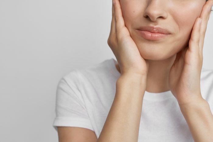 Woman holding jaw