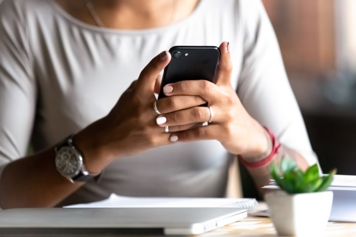 Close up woman holding smartphone