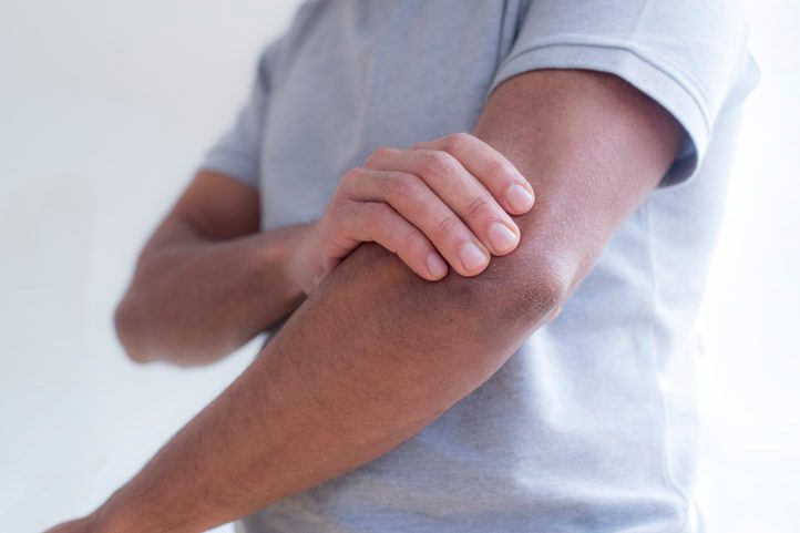 Man touching his elbow in pain