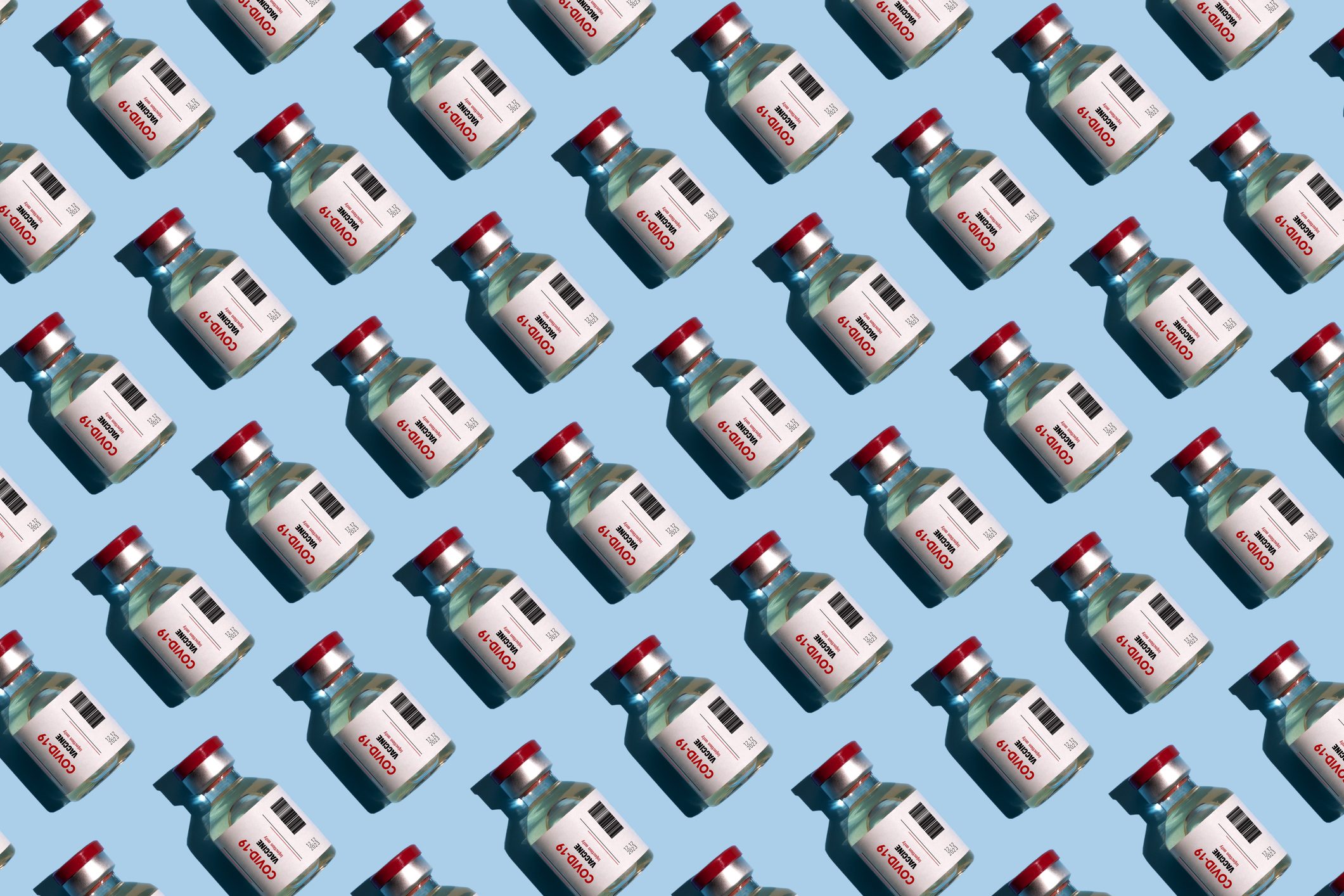 Repeated covid vaccine vials on blue background