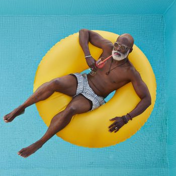 Bald man relaxing in yellow inflatable ring