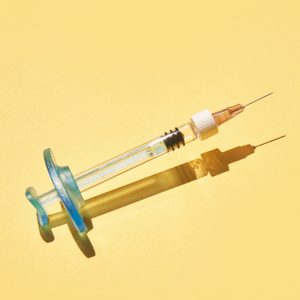 Syringe drug. Doctor injection vaccine. Hard shadow. Healthcare therapy