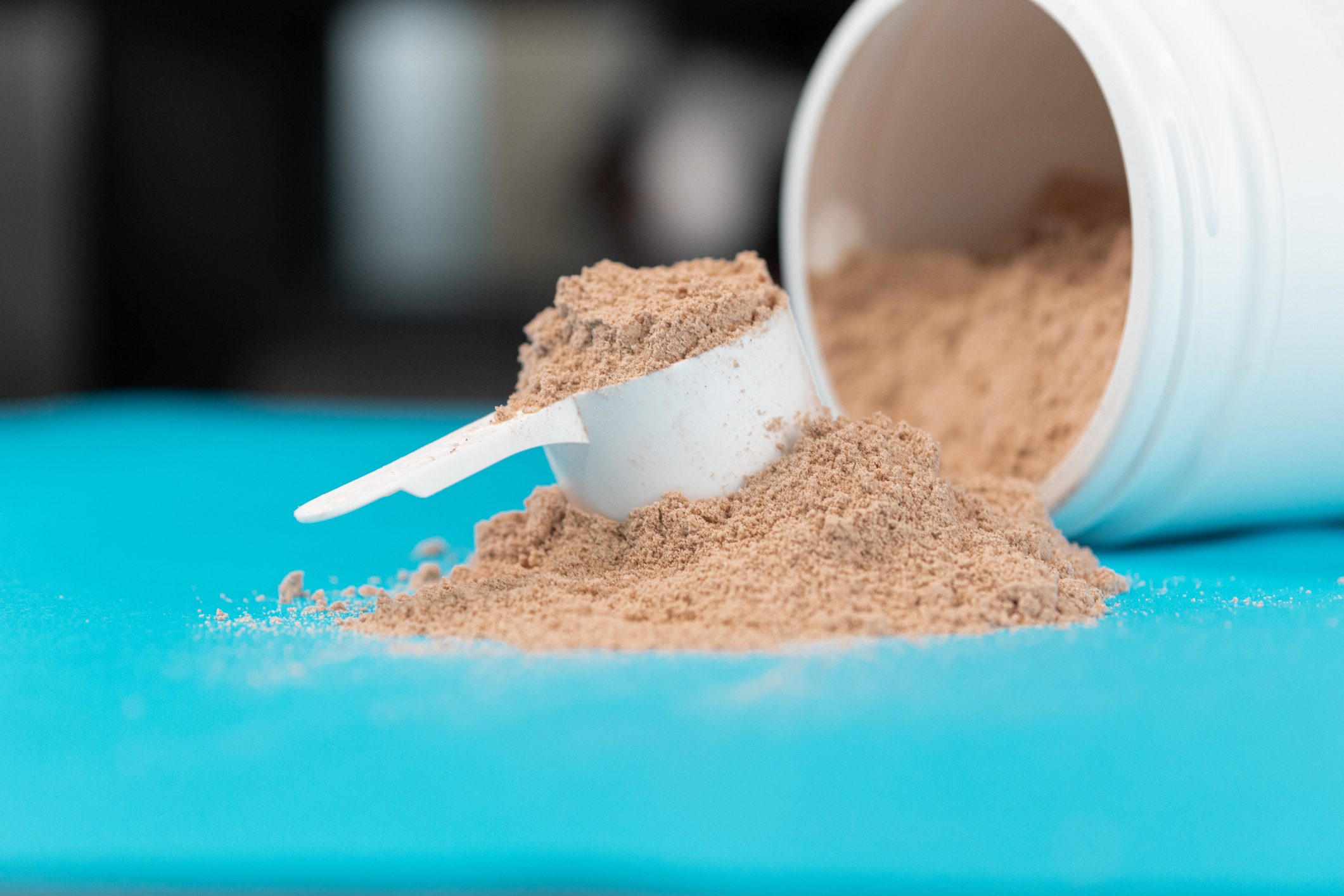 Scoop Filled With Brown Or Chocolate Flavored Protein Powder.