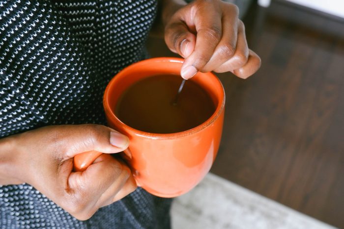 hands holding cup of coffee