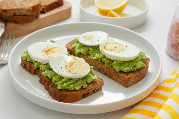 Avocado toast. Sandwich with egg, mashed on wholegrained bread. Healthy breakfast.