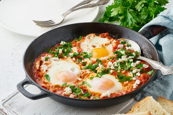 Shakshouka, eggs poached in sauce of tomatoes, olive oil. Mediterranean cuisine.