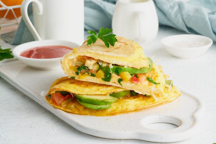 Trendy breakfast with quesadilla and eggs, trending food with omelet, cheese