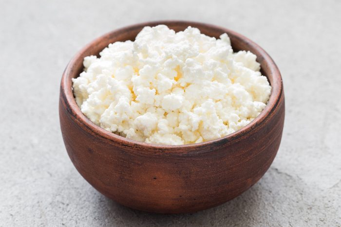 Freshly made cottage cheese in a clay bowl.